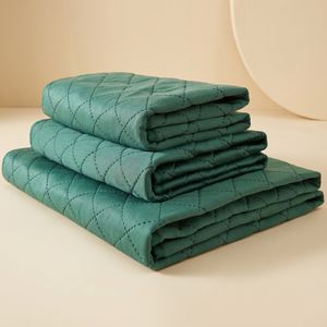 Folded teal quilted pet cooling mat for cats and dogs, cozy comfort for pets