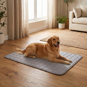 Golden retriever resting on gray quilted cooling mat for dogs in cozy living room