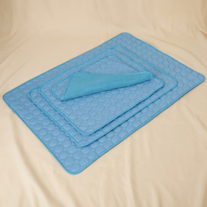 Blue cooling pet mats with quilted design, ideal for cats and dogs comfort