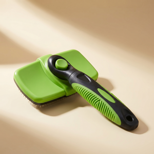 Green and black pet grooming brush with ergonomic handle for cats and dogs