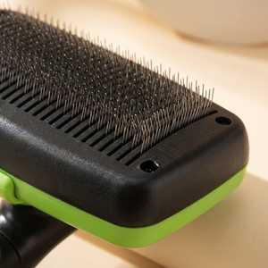 Black and green pet grooming brush with fine metal bristles for cats and dogs