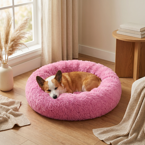Cozy pink fluffy dog bed with Corgi sleeping peacefully near window, perfect for pet comfort and relaxation.