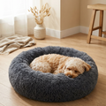Cozy gray fluffy dog bed with small dog sleeping, perfect for pet comfort and calm rest at home.