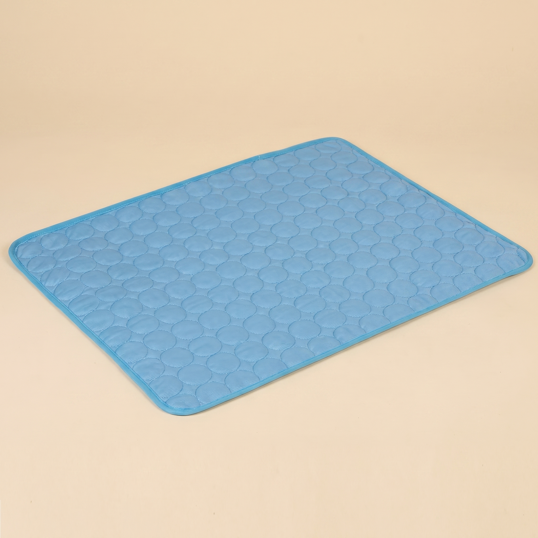 Light blue quilted pet cooling mat with circular pattern for cats and dogs