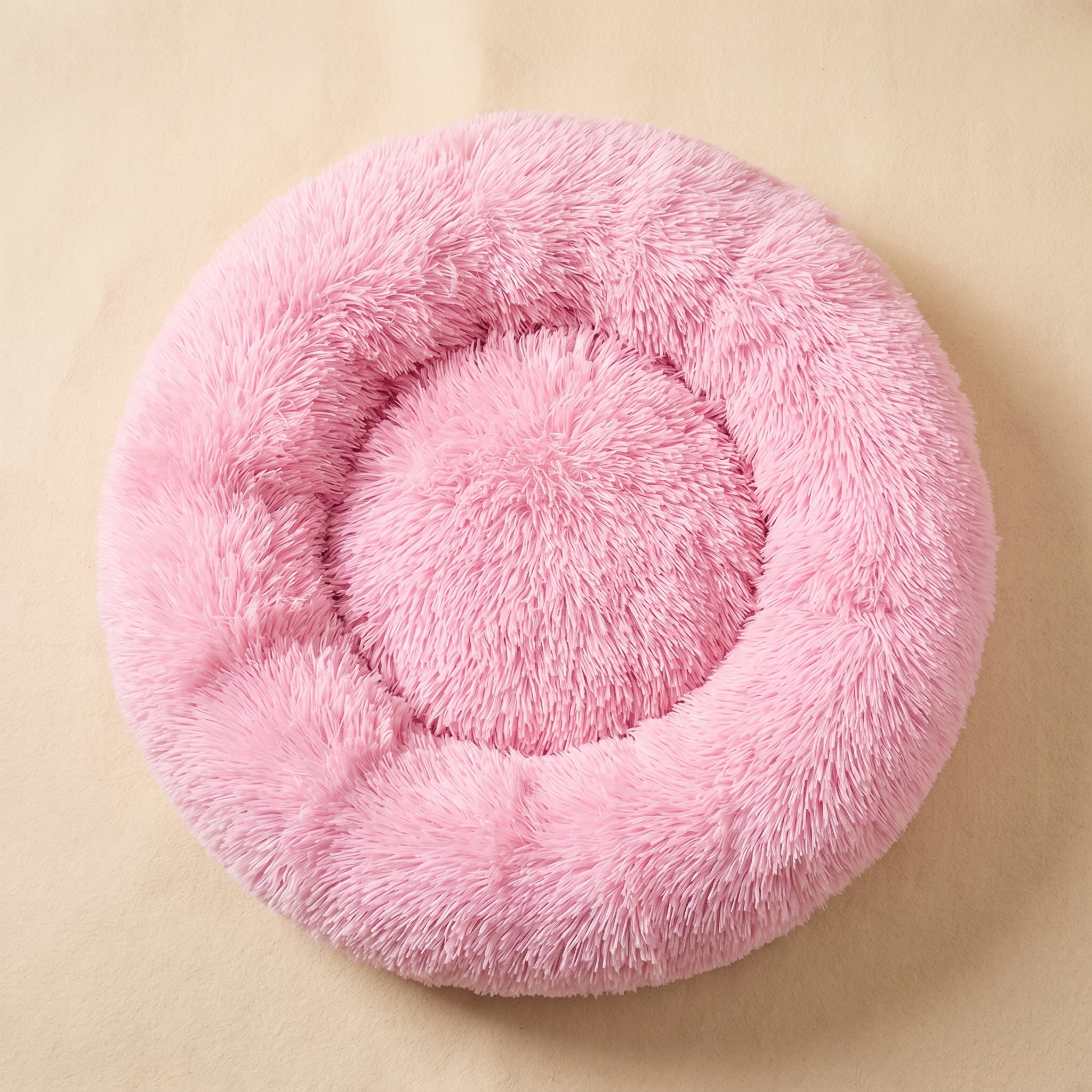 Pink fluffy round pet bed for cats and dogs, cozy and soft comfort